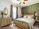 Bedroom with a wood accent wall, modern finishes, and natural light at 2218 Christian Light Rd, Fuquay Varina, NC 27526