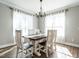 Dining room with elegant chandelier, light-filled windows with light curtains, and a wooden table at 2218 Christian Light Rd, Fuquay Varina, NC 27526