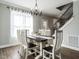 Dining room featuring hardwood floors, staircase, and a chandelier above the wooden table at 2218 Christian Light Rd, Fuquay Varina, NC 27526