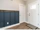 The entryway features updated flooring, stylish wainscoting, and a modern black and white aesthetic at 2218 Christian Light Rd, Fuquay Varina, NC 27526