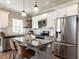 Modern kitchen with stainless steel appliances, granite countertops, and a central island with seating at 2218 Christian Light Rd, Fuquay Varina, NC 27526