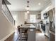 Well-lit kitchen with granite countertops, stainless steel appliances, and hardwood floors at 2218 Christian Light Rd, Fuquay Varina, NC 27526