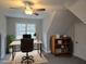 Home office featuring a large desk, ample lighting, and built-in bookshelves at 2218 Christian Light Rd, Fuquay Varina, NC 27526