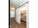Walk-in pantry with white shelves and a stylish sliding barn door at 2218 Christian Light Rd, Fuquay Varina, NC 27526