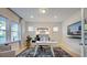 Bright home office with large windows and a modern black and white rug at 249 Tidal Pool Way, Cary, NC 27513