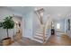 Inviting foyer with wood floors and a staircase leading to the second floor at 249 Tidal Pool Way, Cary, NC 27519
