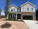 Beautiful two-story home with a brick and gray shingle exterior and attached garage at 249 Tidal Pool Way, Cary, NC 27519