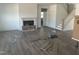 Bright living room featuring wood floors, a cozy fireplace, staircase to the second floor, and natural light at 249 Tidal Pool Way, Cary, NC 27519