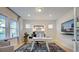 Bright home office featuring large windows and modern furnishings at 249 Tidal Pool Way, Cary, NC 27519