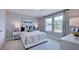 Well-lit bedroom with carpet, large window, decorative curtains, and a cozy bed setup at 253 Tidal Pool Way, Cary, NC 27519