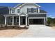 Charming two-story home showcasing its architectural design, inviting entrance, and well-manicured landscaping at 253 Tidal Pool Way, Cary, NC 27519