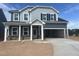 Two-story home featuring mixed siding, a stone water table, and an attached two-car garage at 253 Tidal Pool Way, Cary, NC 27519