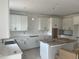Spacious kitchen with white cabinets, a tile backsplash, quartz counters, and stainless steel appliances at 253 Tidal Pool Way, Cary, NC 27519