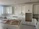 Spacious kitchen with white cabinets, a tile backsplash, quartz counters, and stainless steel appliances at 253 Tidal Pool Way, Cary, NC 27519
