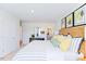 Bright bedroom featuring striped bedding, wooden headboard, decorative art and natural light at 309 Cherry Laurel Dr, Sanford, NC 27332