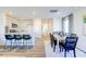 Open-concept living space with kitchen island, dining table and chairs, and hardwood floors at 309 Cherry Laurel Dr, Sanford, NC 27332