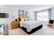 Bright bedroom with a large window, striped bedding, and stylish bedside tables at 309 Cherry Laurel Dr, Sanford, NC 27332