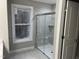 Bright bathroom features a glass shower and a large window, offering natural light and a modern feel at 3204 Overlook Ct, Burlington, NC 27215