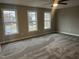 Bedroom featuring neutral walls and carpet with a ceiling fan and windows at 3204 Overlook Ct, Burlington, NC 27215