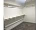 Spacious walk-in closet featuring custom shelving and clothing rods, perfect for organizing wardrobes and accessories at 3204 Overlook Ct, Burlington, NC 27215