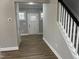 Hallway leads to a white front door, with wood-look floors and a staircase visible at 3204 Overlook Ct, Burlington, NC 27215