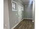 Inviting entryway featuring a white front door, neutral walls, trim, and wood-look flooring at 3204 Overlook Ct, Burlington, NC 27215