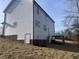Exterior view of a two-story home with white siding and a back deck overlooking the spacious backyard at 3204 Overlook Ct, Burlington, NC 27215