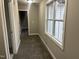 Hallway featuring neutral walls and carpet leading to another room and window at 3204 Overlook Ct, Burlington, NC 27215