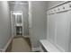 Hallway featuring mudroom bench and hooks, bathroom, neutral walls, and wood-look flooring at 3204 Overlook Ct, Burlington, NC 27215