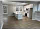 Bright kitchen featuring white cabinets, granite countertops, stainless steel appliances, and beautiful hardwood floors at 3204 Overlook Ct, Burlington, NC 27215