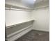 Walk-in closet with carpet flooring and white shelving and closet rods at 3204 Overlook Ct, Burlington, NC 27215