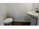 Half bathroom with pedestal sink and hardwood floors at 3287 Roundly Rd # 13, New Hill, NC 27562