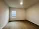Neutral bedroom with hardwood flooring and a bright window at 3287 Roundly Rd # 13, New Hill, NC 27562