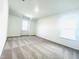 Large bedroom featuring neutral carpeting and a pair of bright windows at 3287 Roundly Rd # 13, New Hill, NC 27562
