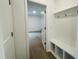 Entryway featuring hardwood floors, storage bench with hooks, and a view into the house at 3287 Roundly Rd # 13, New Hill, NC 27562