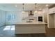 Bright, modern kitchen with stainless steel appliances, pendant lighting, and a large kitchen island at 3287 Roundly Rd # 13, New Hill, NC 27562
