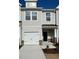 Charming townhome with a one car garage, neutral siding, stone accents, and a covered porch at 343 Church St # 66, Wendell, NC 27591