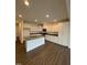 Bright kitchen featuring white cabinets, granite countertops, stainless steel appliances, and an island at 343 Church St # 66, Wendell, NC 27591