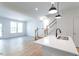 Bright kitchen featuring stainless steel appliances, white cabinets, and an island with pendant lighting at 343 Church St # 66, Wendell, NC 27591