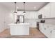 Stylish kitchen with white cabinets, stainless steel appliances, and a convenient island layout at 343 Church St # 66, Wendell, NC 27591