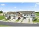 New townhomes featuring modern architecture, attached garages, and lush landscaping at 345 Church St # 65, Wendell, NC 27591