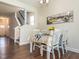 Inviting dining area with stylish table setting and artwork, adjacent to the stairway at 347 Church St # 64, Wendell, NC 27591