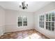 Dining room with tile floor, chair rail, and large windows at 3883 Pin Oak Rd, Raleigh, NC 27604