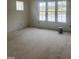 Sunny bedroom featuring three windows overlooking the serene lake at 395 Meadow Walk Dr, Fuquay Varina, NC 27526