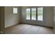 Bedroom featuring a large window with a beautiful view, new construction at 395 Meadow Walk Dr, Fuquay Varina, NC 27526