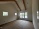 Bright bedroom featuring vaulted ceilings with wooden beams and large windows letting in natural light at 395 Meadow Walk Dr, Fuquay Varina, NC 27526