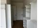 Custom walk-in closet featuring built-in shelves, cabinets, and a dark floor with blue painter's tape at 395 Meadow Walk Dr, Fuquay Varina, NC 27526