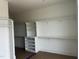 Walk-in closet with an abundance of custom white shelves, cabinets, and storage options at 395 Meadow Walk Dr, Fuquay Varina, NC 27526