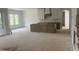 Spacious kitchen area with white cabinets and a gray kitchen island under construction at 395 Meadow Walk Dr, Fuquay Varina, NC 27526