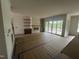 Spacious living room with fireplace and floating shelves, as well as a clear view to covered back porch at 395 Meadow Walk Dr, Fuquay Varina, NC 27526